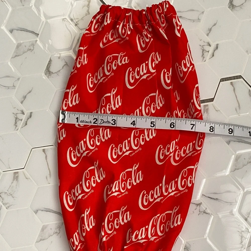 Handmade wall hanging grocery bags organizer and pantry with Coca Cola logo.